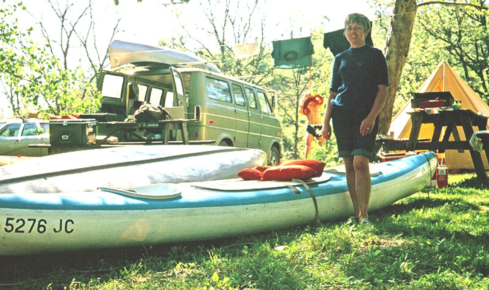 Peggy standing with a new canoe at a Keel-Haulers camp in 1969
